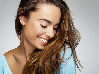 The image features two photographs of a woman with long hair smiling at the camera. She appears to be wearing a light-colored top, and her posture suggests a relaxed and friendly demeanor.